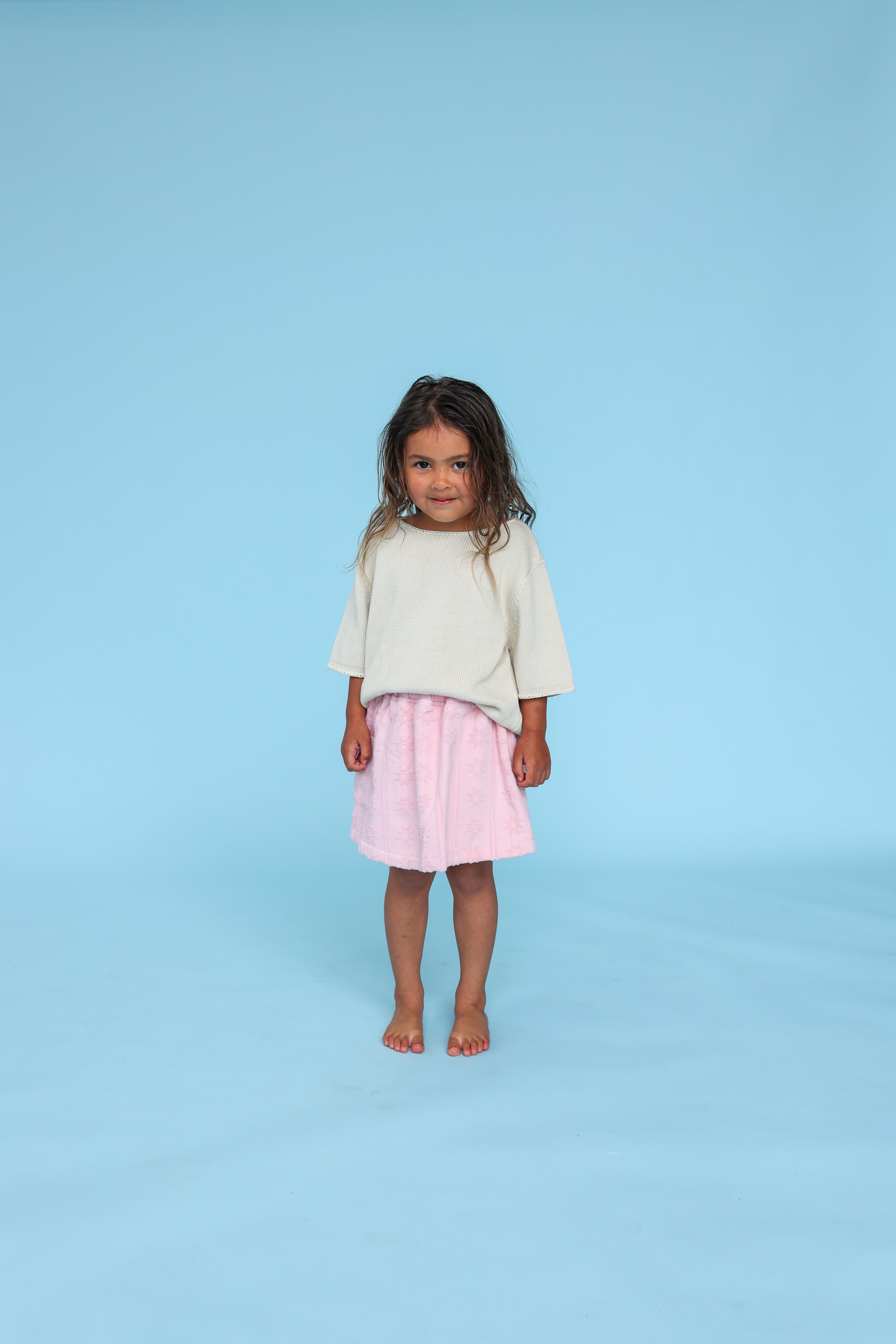 girl wearing 100% organic cotton blanket stitch kids tshirt in dune colour