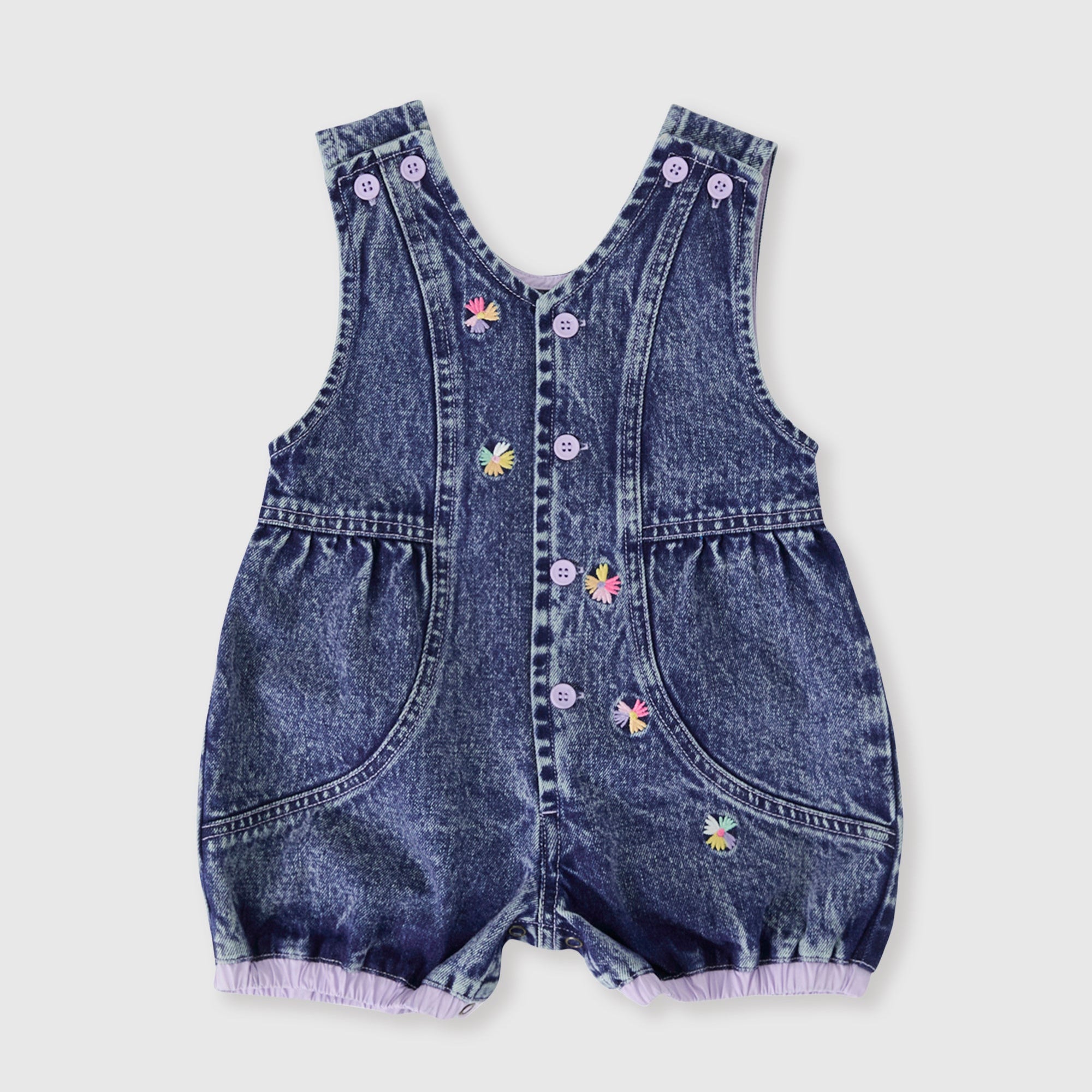 Denim baby romper with floral embroidery on a light gray background