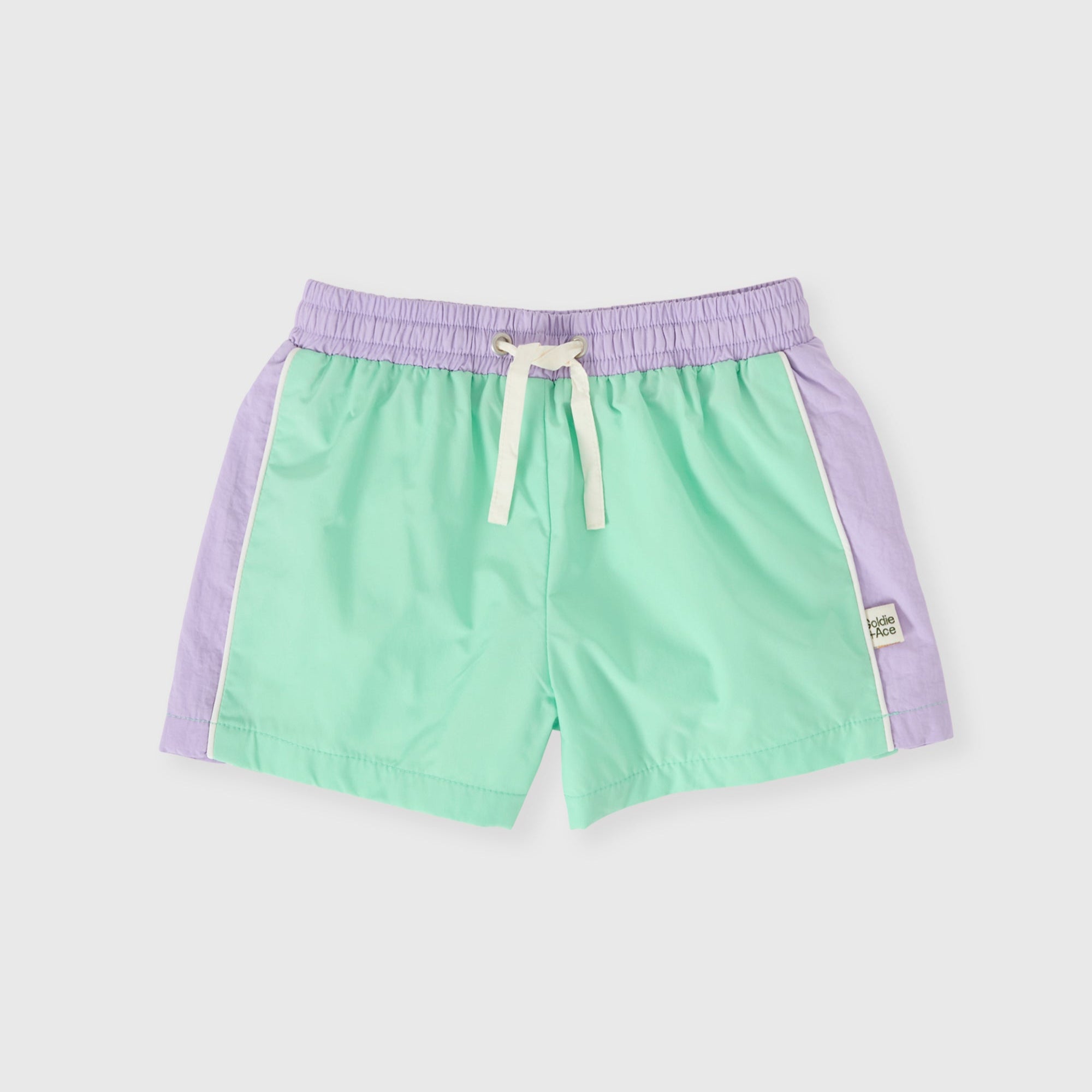 Green shorts with purple accents on a light gray background